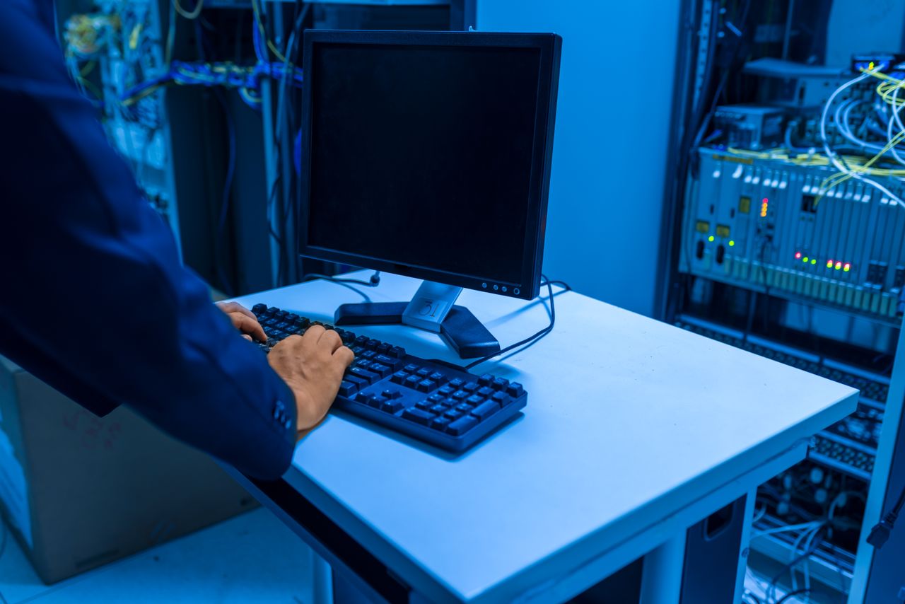 stats-img An IT professional operates a computer in a server room, managing network systems and connected devices.